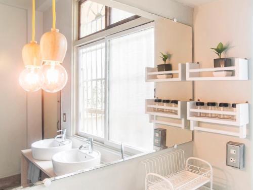 a bathroom with two sinks and a large mirror at Tainan Gu Hostel in Tainan