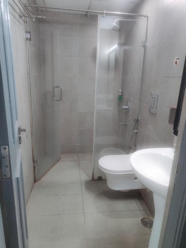 a bathroom with a shower and a toilet and a sink at Hotel CINCO PRIME -PREMIUM ROOMS in Secunderabad