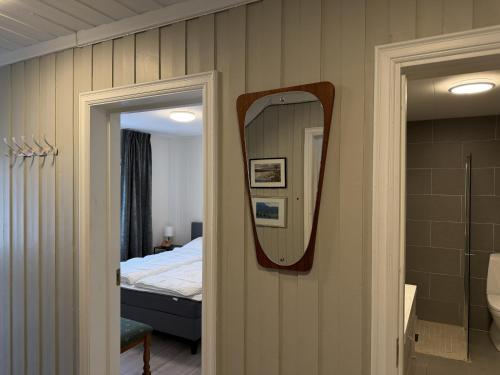a bathroom with a mirror next to a bed at Spacious apartment in Follebu in Aulestad