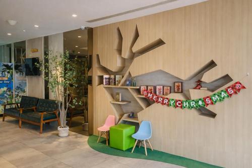 a lobby with a christmas decoration on a wall at A Hotel Joo Chiat in Singapore