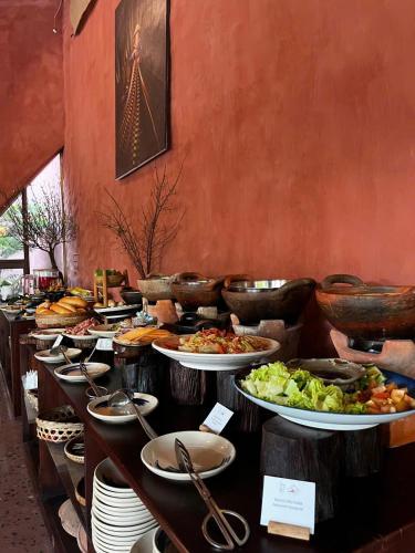 a buffet line with plates and bowls of food at Mekong Silt Ecolodge - Swimming Pool & Free Breakfast in Can Tho