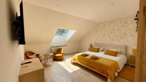 a bedroom with a large bed and a window at L'Echo du Bonheur in Vaumas