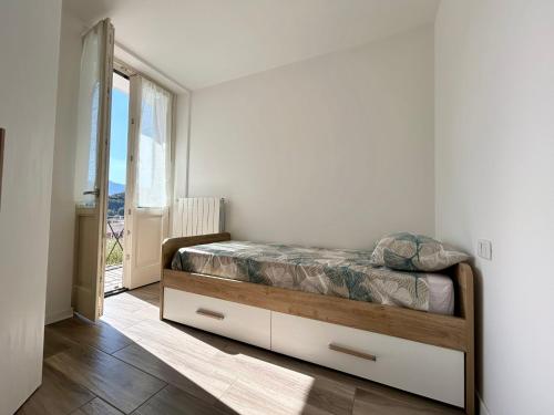 a bedroom with a bed in a room with a window at Relax Home in Clusone