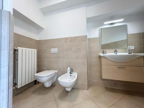 a bathroom with a toilet and a sink at Relax Home in Clusone