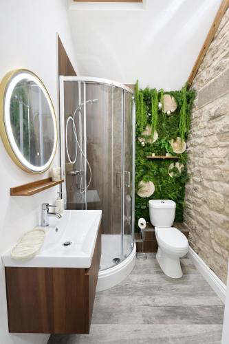 a bathroom with a shower and a toilet and a sink at The Garden Hideaway Central Corbridge in Corbridge