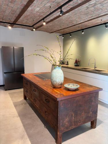 a vase sitting on top of a table in a kitchen at Vakantiewoning in monumentale boerderij met yurt in Eckelrade