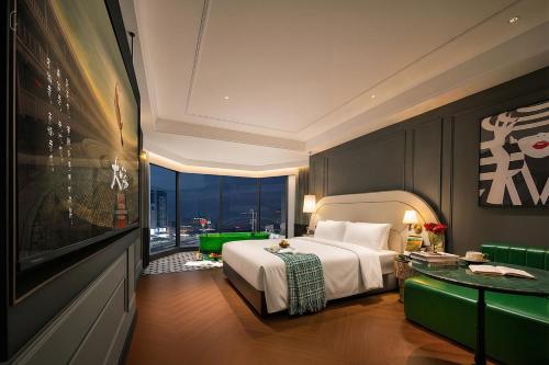 a bedroom with a bed and a large window at 总统號外酒店 President HaoWai Hotel Guangzhou in Guangzhou