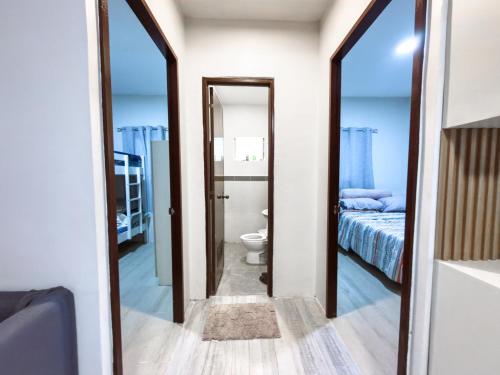 a bathroom with a toilet and a bed and a mirror at Davon- Doña Soledad in Polon