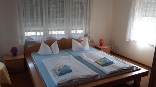 a bed in a bedroom with two pillows on it at Pension Partzsch in Siebenlehn