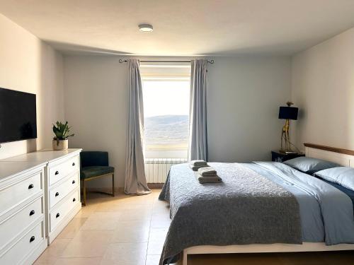 a bedroom with a bed and a window at The View in Motovun