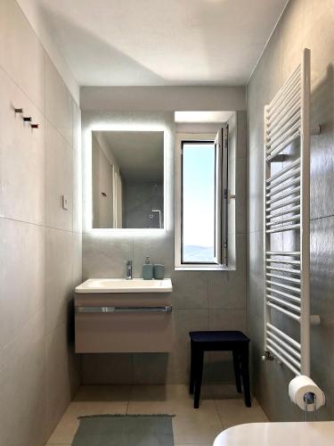 a bathroom with a sink and a mirror and a window at The View in Motovun