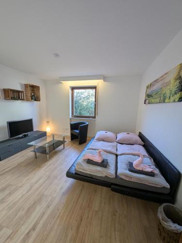 a bedroom with a large bed and a living room at Weinbergnest in Bad Dürkheim