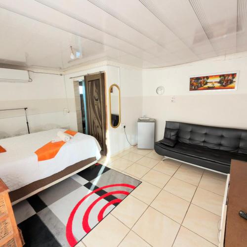 a bedroom with a bed and a couch at Godmill guesthouse Taung in Lethola