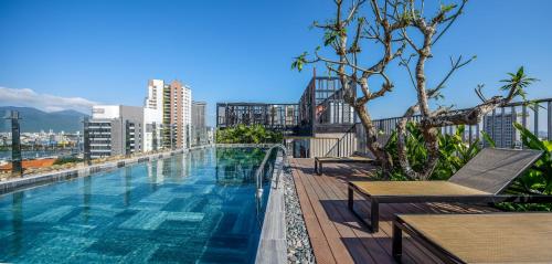 a swimming pool on top of a building at Tropical Dorm Hostel Da Nang by Haviland in Danang