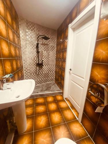 a bathroom with a toilet and a sink and a shower at Ayanchin Hotel in Ulaanbaatar