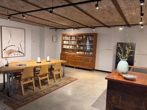 a dining room with a wooden table and chairs at Vakantiewoning in monumentale boerderij met yurt in Eckelrade