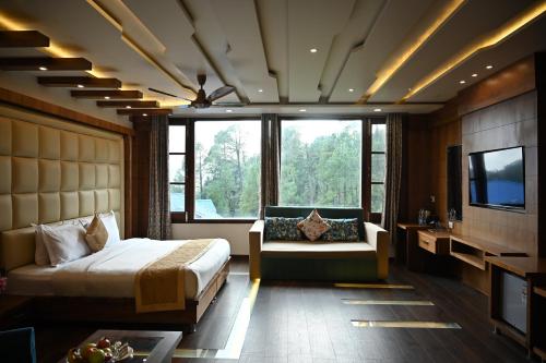 a bedroom with a bed and a tv and a couch at The Hoften Blue Magnets, Dalhousie in Dalhousie