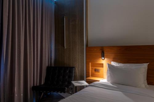 Tempat tidur dalam kamar di Reno hotel
