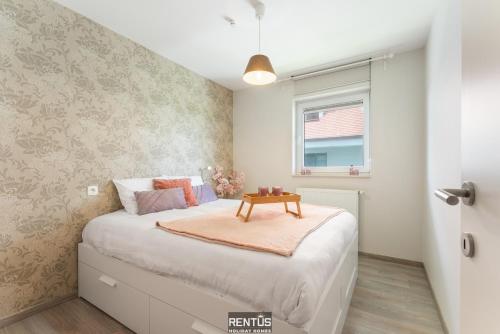 a bedroom with a bed with a table on it at Seange - with beautiful view and many facilities in Nieuwpoort