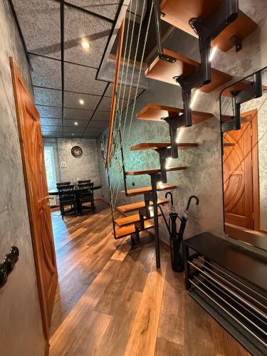 a spiral staircase in a room with a table at BRIVIBAS RESIDENCE - WAVE, free PRIVATE parking, free WIFI, self check-in in Riga