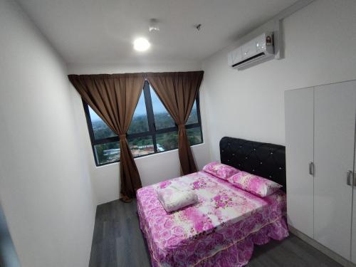 a bedroom with a pink bed and a window at Halimah Guesthouse in Putatan