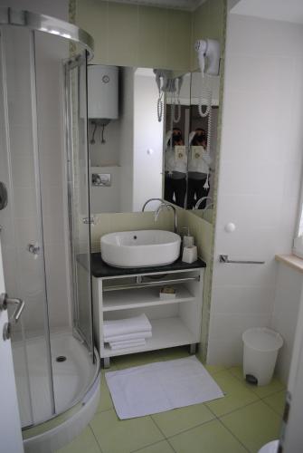 a bathroom with a sink and a shower at Rooms Piazzetta in Cres