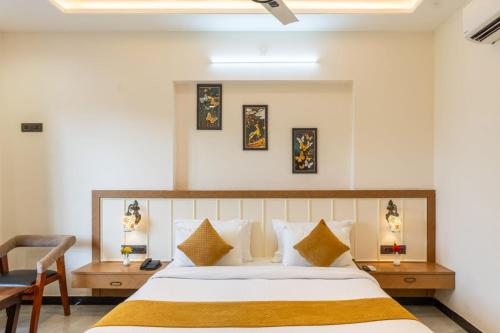 a bedroom with a large bed and a chair at Milestone Resort in Thūr