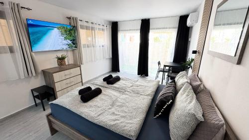 a bedroom with a bed with two pillows on it at Chloraka Bay Studio in Khlorakas
