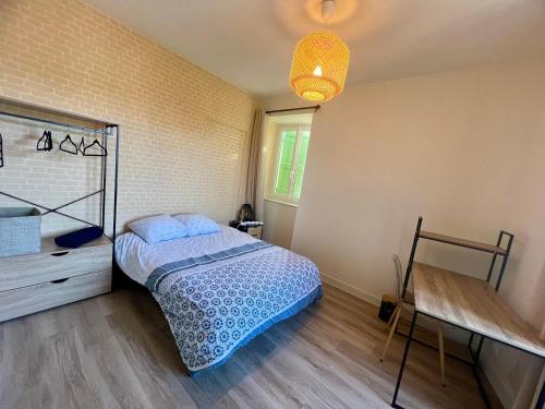 a bedroom with a bed and a dresser in it at Maison de la Gour MELLE in Melle