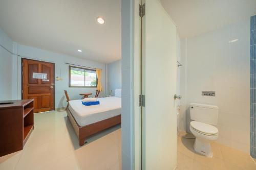 a bathroom with a bed and a toilet and a sink at Chaorua Hotel in Ko Phra Noi