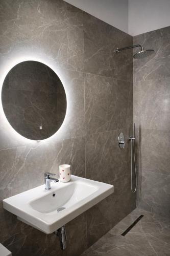 a bathroom with a sink and a shower at Dior Apartment in Vlorë