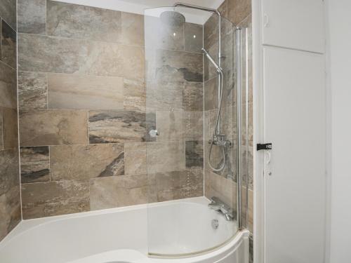 a bathroom with a shower and a tub and a toilet at Lavender Harmony House in Swindon