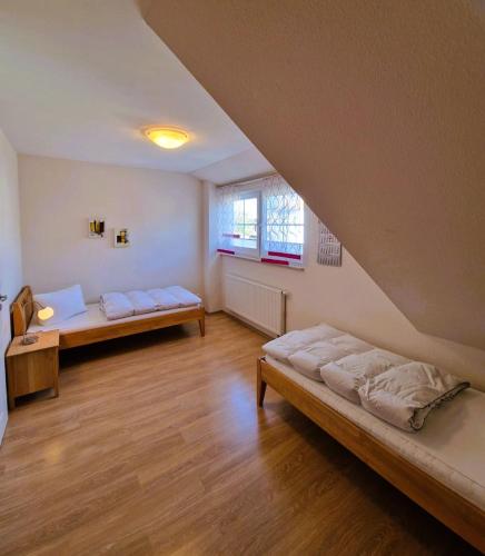 a large room with two beds and a window at Strandstr_ in Zingst