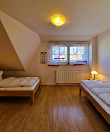 a large room with two beds and a window at Strandstr_ in Zingst