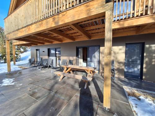a wooden deck with a wooden bench on a house at Chalet Dinkel in Niedernsill in Niedernsill