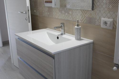 a bathroom with a white sink and a mirror at Il silenzio delle colline Umbre - Vicino Todi in Todi
