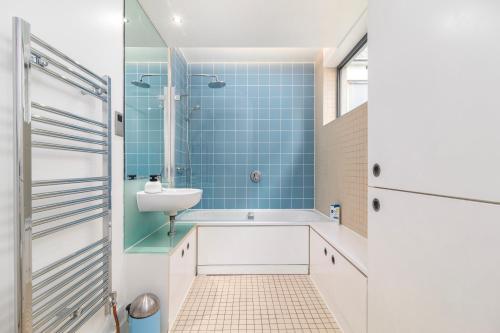 a bathroom with a sink and a shower at City of London 2BR Penthouse with Stunning Terrace View & Air Condition in London