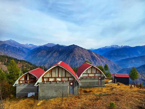 a group of buildings on top of a mountain at The Ridge Cottages - Sainj Valley in Sainj