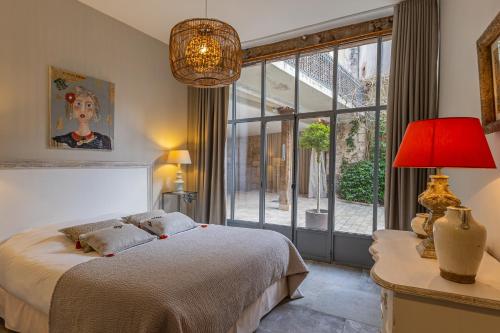 a bedroom with a bed and a large window at Maison Joséphine avec garage privé in Blois