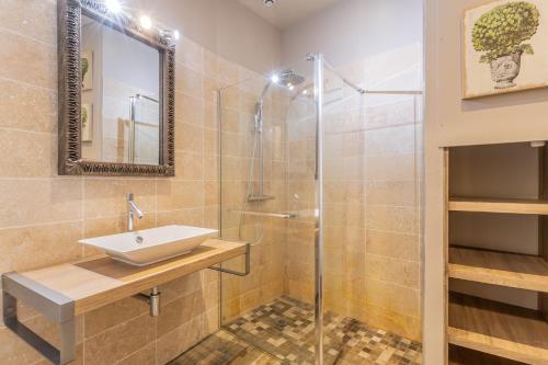 a bathroom with a sink and a shower at Maison Joséphine avec garage privé in Blois