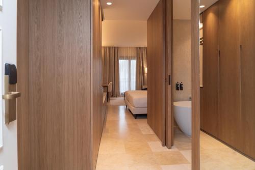 a room with a bathroom with a bed and a tub at SH Villa Gadea in Altea