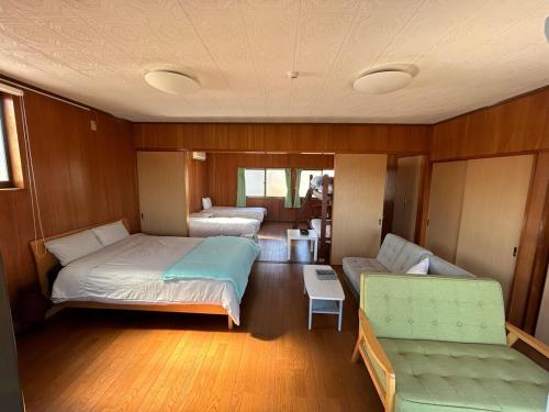 a room with a bed and a couch in a boat at VOYAGE Beautiful sunrise ocean view BEDROOM whole house, 2 rooms on 2nd floor, tatami room on 1st floor, &private garage in Hyuga