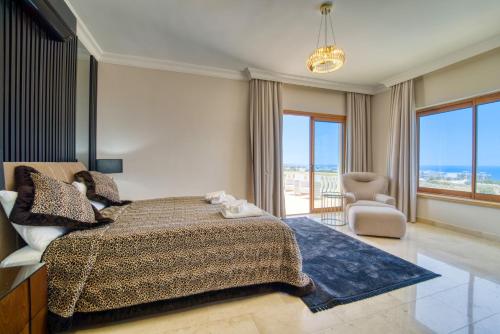 a bedroom with a bed and a view of the ocean at Sunset Poseidon by Carrington in Kyrenia