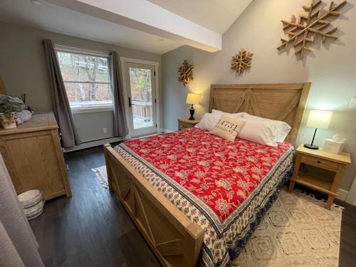 a bedroom with a large bed with a red blanket at Mountain bike Ski Eville Mecca in Ellicottville