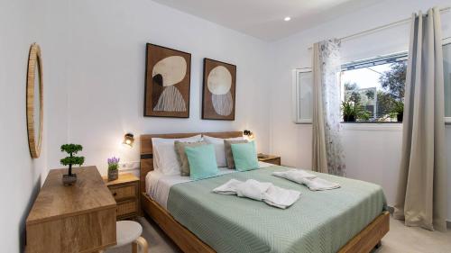 a bedroom with a bed with a desk and a window at Villa Filothea with Jacuzzi & SV by CorfuEscapes in Spartýlas