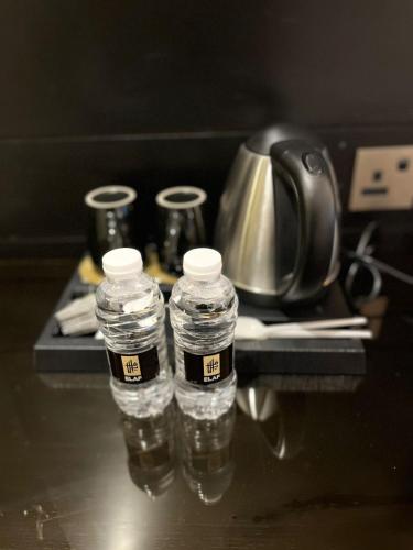 two bottles of water sitting on a table at Elaf Al Sagryah Hotel in Mecca