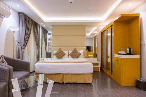 a hotel room with a bed and a couch at Al Muahidb Residence Al Takhasossi 4 - Economic in Riyadh