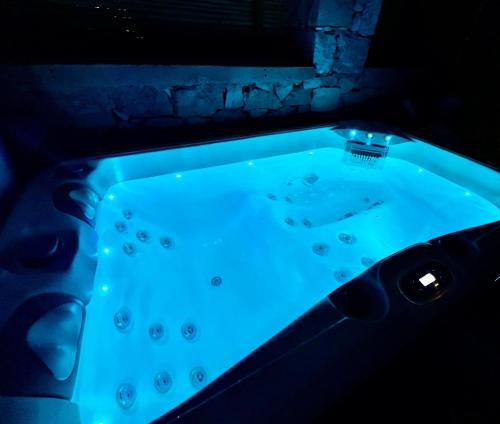 a jacuzzi tub with blue lighting in a room at Petromilos1920 in Zefiría