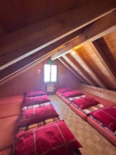 a room with four beds in a attic at Alpwirtschaft Heirihütte in Rigi Klösterli
