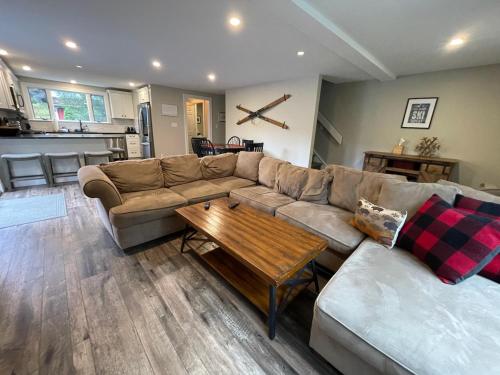 a living room with a couch and a coffee table at SKI Bike, Hike & Golf Townhouse w/ Hot tub in Ellicottville